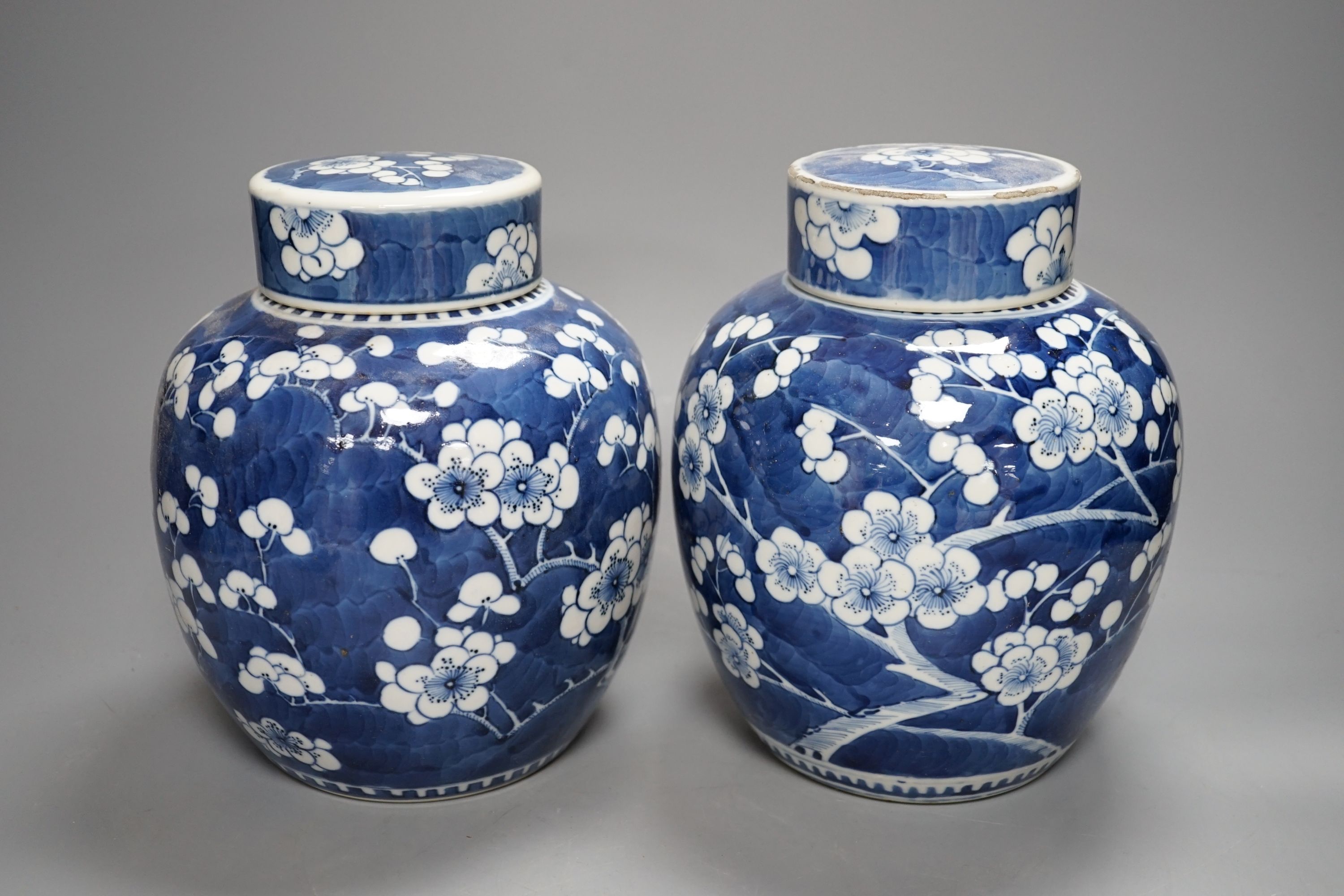 A pair of Chinese blue and white ginger jars and covers, 22 cms high including cover.